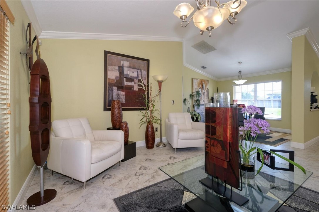 18246 Sycamore Road Fort Myers, FL 33967 - Photo 13 of 35 a living room with furniture a chandelier and a mirror