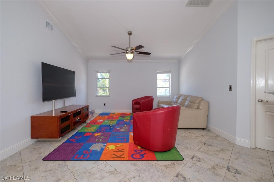 18246 Sycamore Road Fort Myers, FL 33967 - Photo 14 of 35 a living room with furniture and a flat screen tv