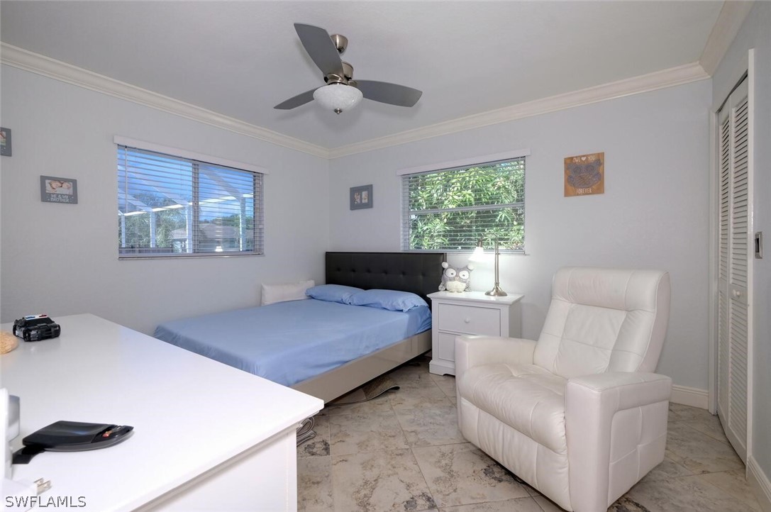 18246 Sycamore Road Fort Myers, FL 33967 - Photo 19 of 35 a bedroom with a bed couch and window