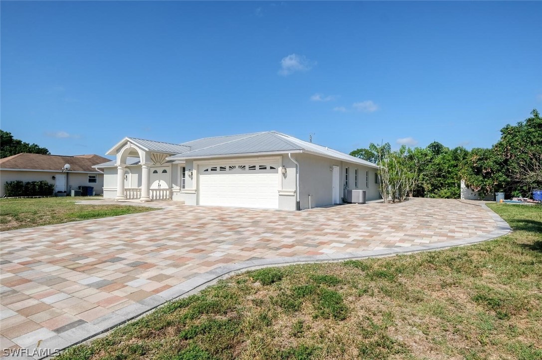 18246 Sycamore Road Fort Myers, FL 33967 - Photo 2 of 35 a view of a house with a yard and garage