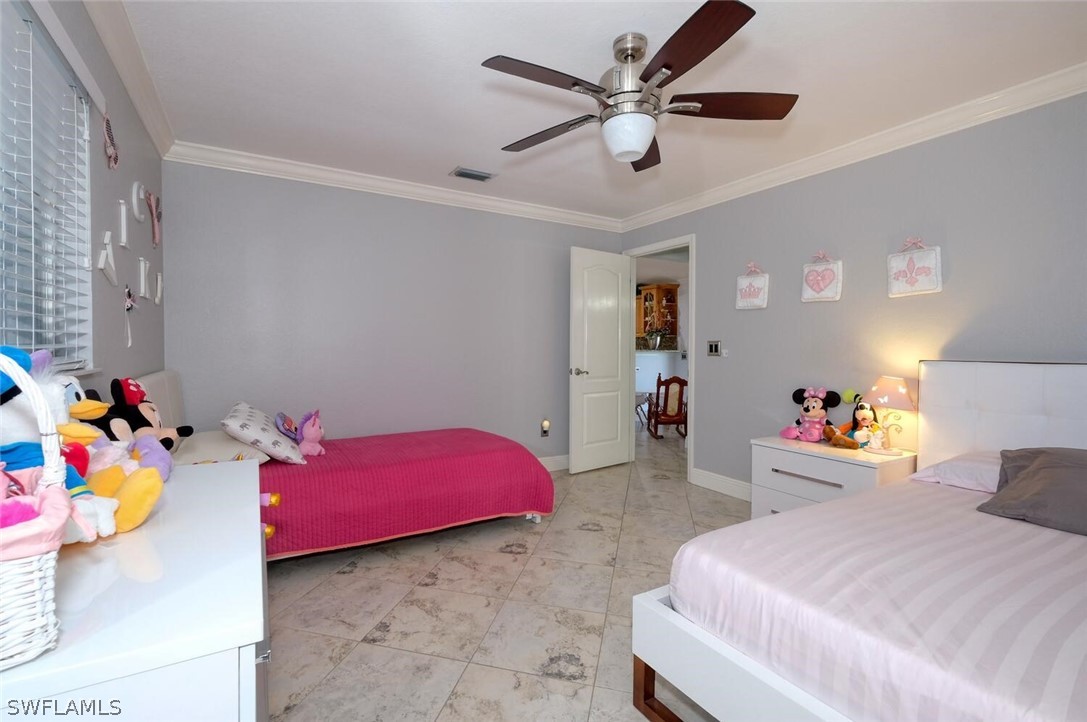 18246 Sycamore Road Fort Myers, FL 33967 - Photo 21 of 35 a bedroom with bed and a chandelier