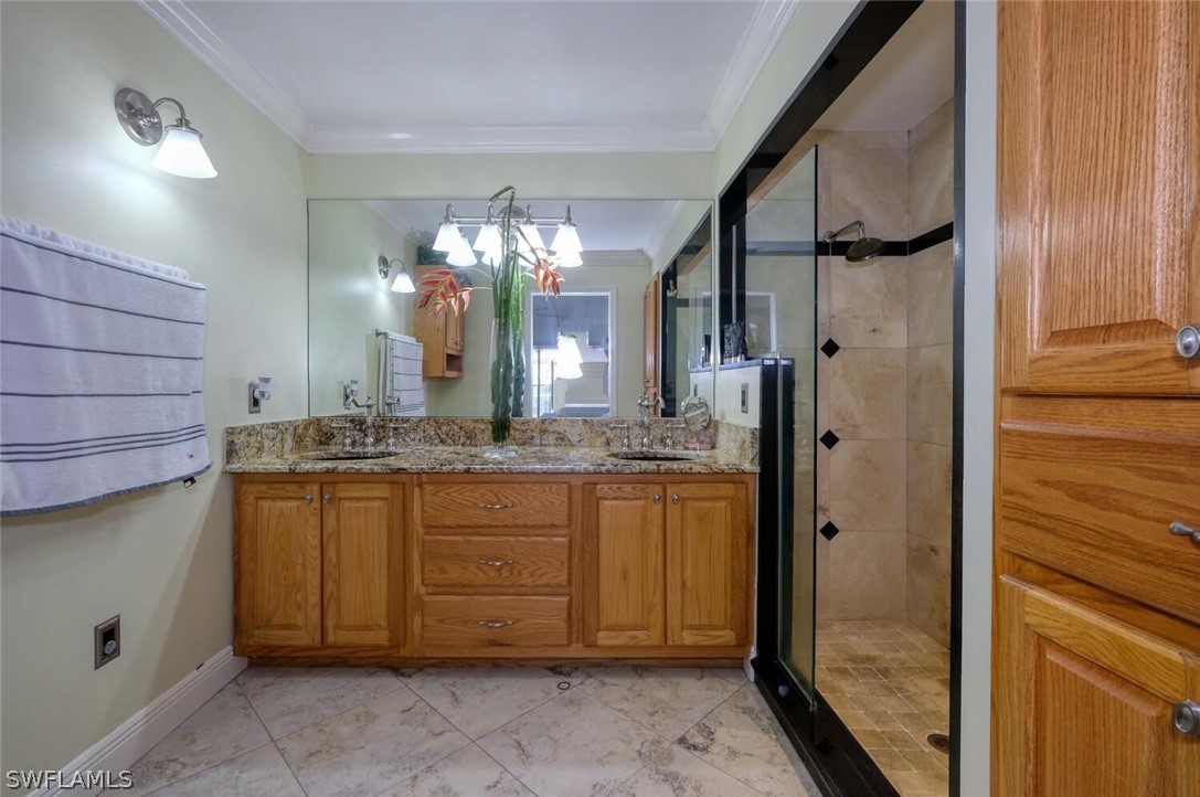 18246 Sycamore Road Fort Myers, FL 33967 - Photo 24 of 35 a bathroom with a granite countertop sink a mirror and a shower