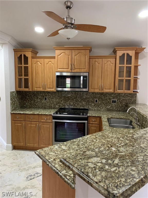 18246 Sycamore Road Fort Myers, FL 33967 - Photo 9 of 35 a kitchen with stainless steel appliances granite countertop a sink stove and cabinets