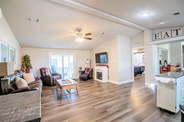 a living room with furniture and a wooden floor
