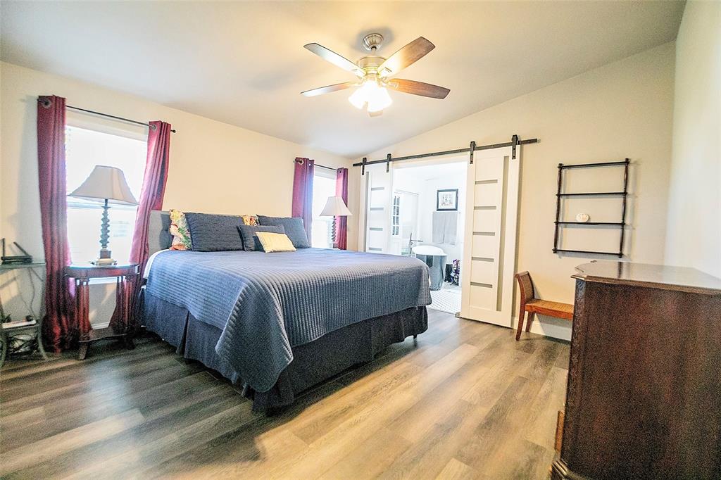 11661 Dane Road Pilot Point, TX 76258 - Photo 16 of 40 a living room with a bed furniture and a large window