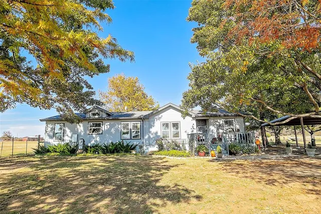 a view of a house with a tree in the background