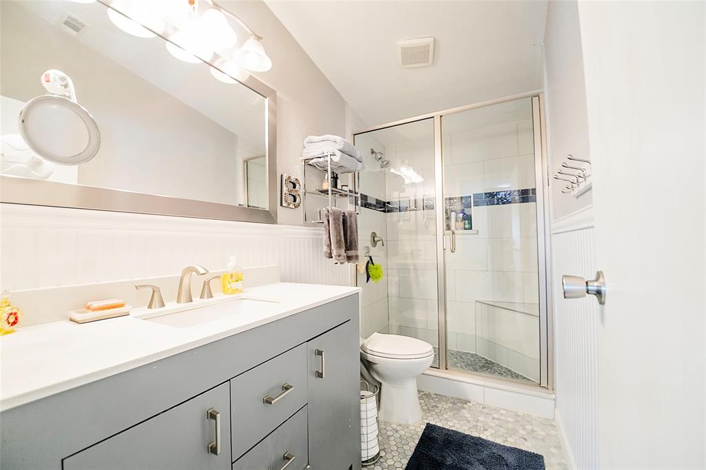 11661 Dane Road Pilot Point, TX 76258 - Photo 21 of 40 a bathroom with a sink a toilet and shower