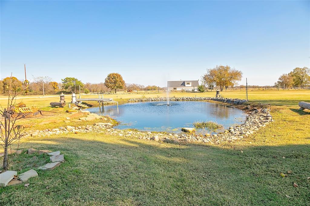11661 Dane Road Pilot Point, TX 76258 - Photo 23 of 40 a view of a lake with houses in the back