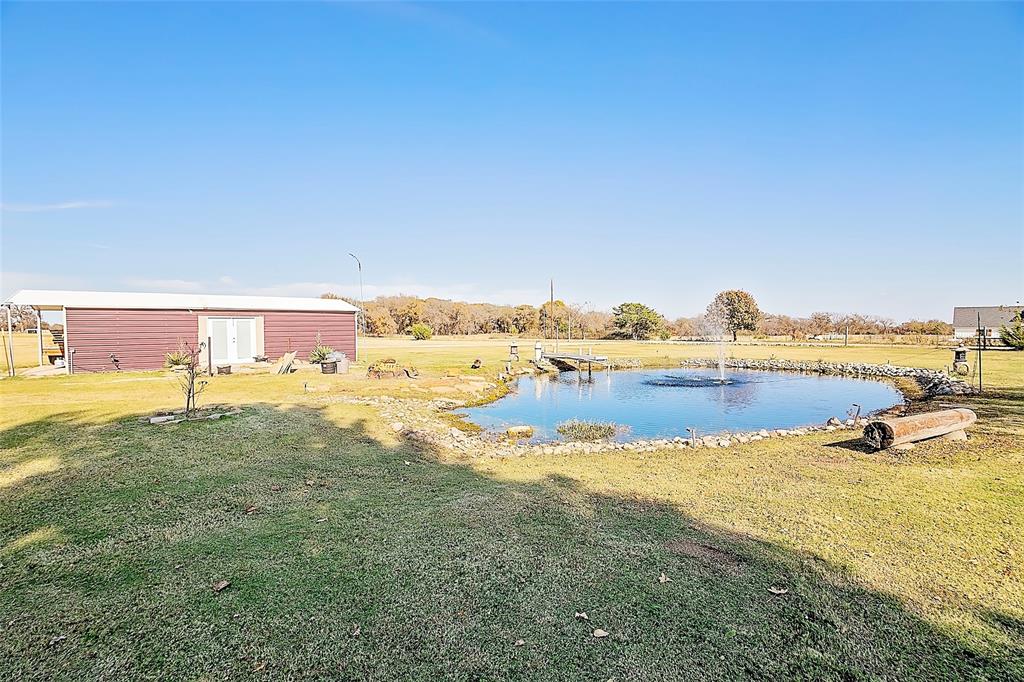 11661 Dane Road Pilot Point, TX 76258 - Photo 24 of 40 a view of a lake with beach