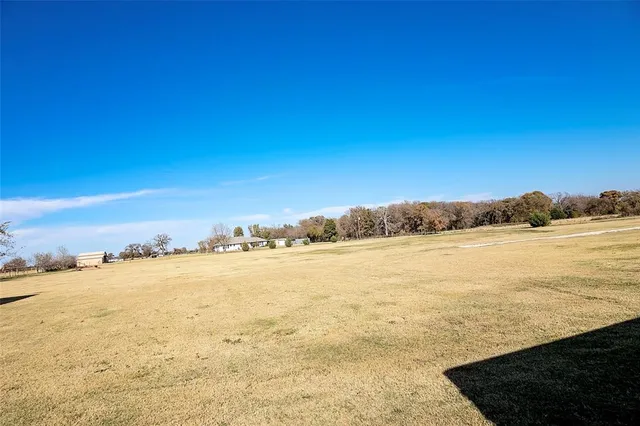 a swimming pool with outdoor seating and yard