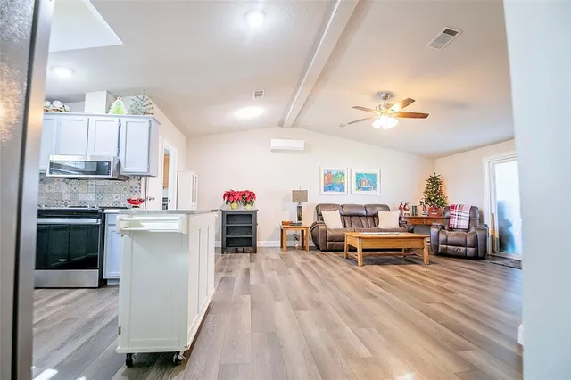 a kitchen view with microwave a stove and cabinets