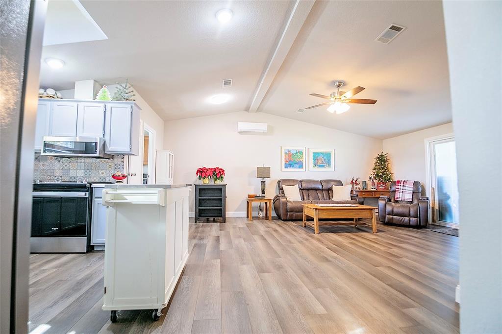 11661 Dane Road Pilot Point, TX 76258 - Photo 9 of 40 a kitchen view with microwave a stove and cabinets