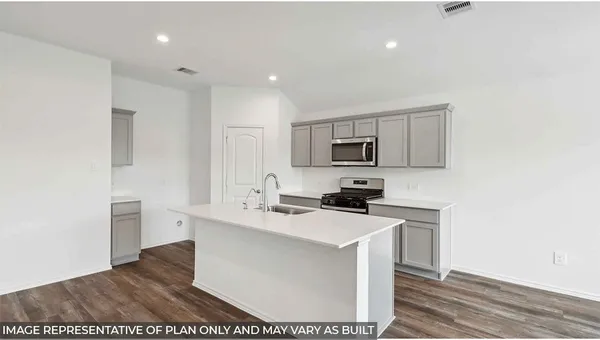 a kitchen with stainless steel appliances a sink stove and cabinets