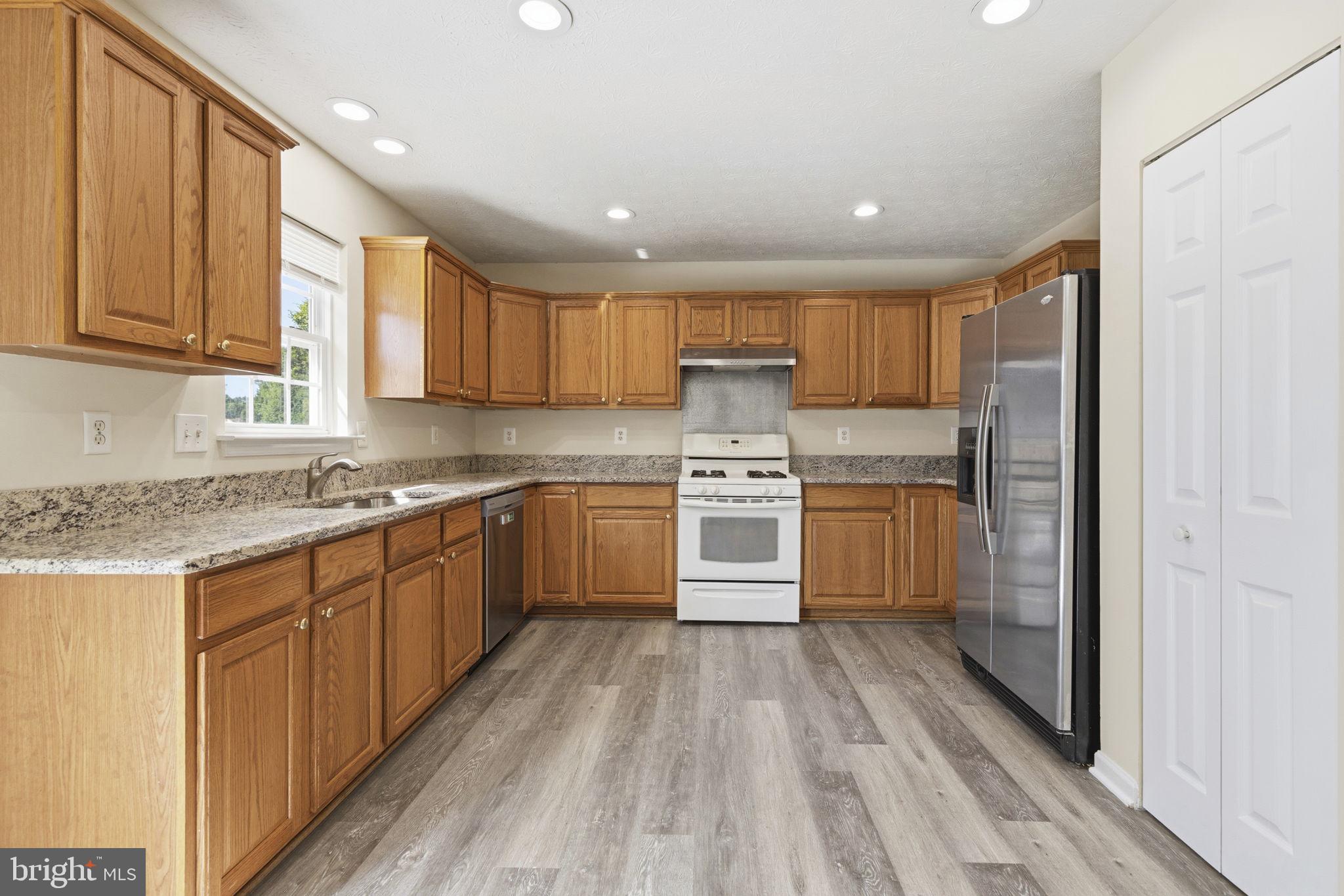 2801 Profitt Path Edgewood, MD 21040 - Photo 5 of 32 a kitchen with stainless steel appliances granite countertop a stove a sink and a refrigerator