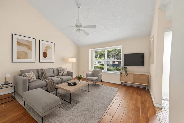 a living room with furniture and a flat screen tv