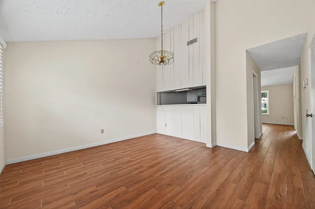 a view of a room with wooden floor