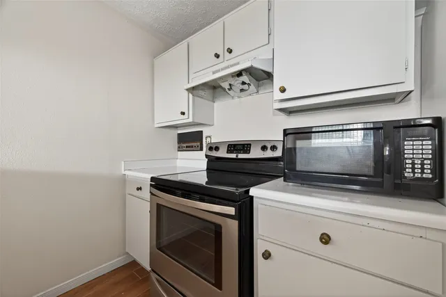 a stove top oven sitting inside of a kitchen