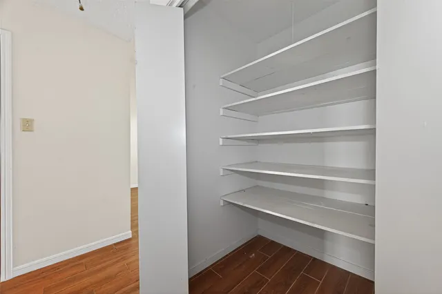 a view of walk in closet with empty racks