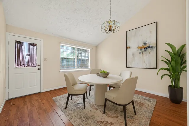 a view of a dining room with furniture window and wooden floor