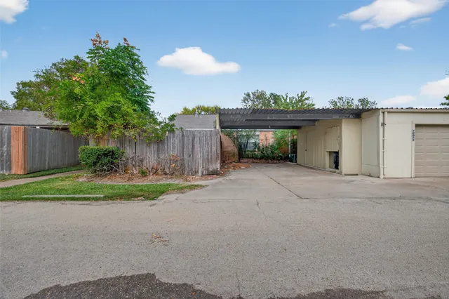 a view of a house with a yard and a garage