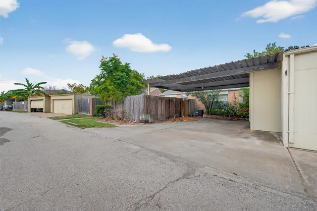 a house with a yard and a wooden fence