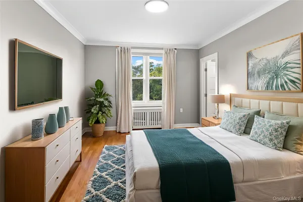 a bedroom with bed and flat screen tv