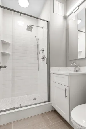 a bathroom with a shower toilet and sink