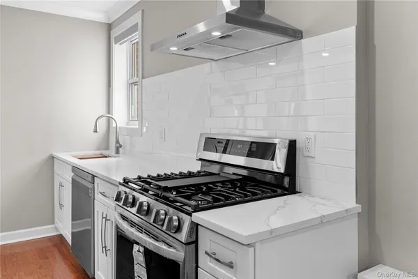 a kitchen with a stove and a sink