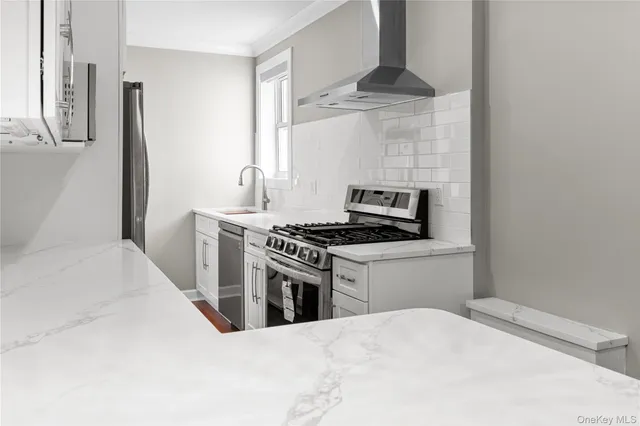 a kitchen with stainless steel appliances a stove and a refrigerator