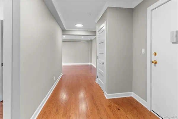a view of hallway with wooden floor