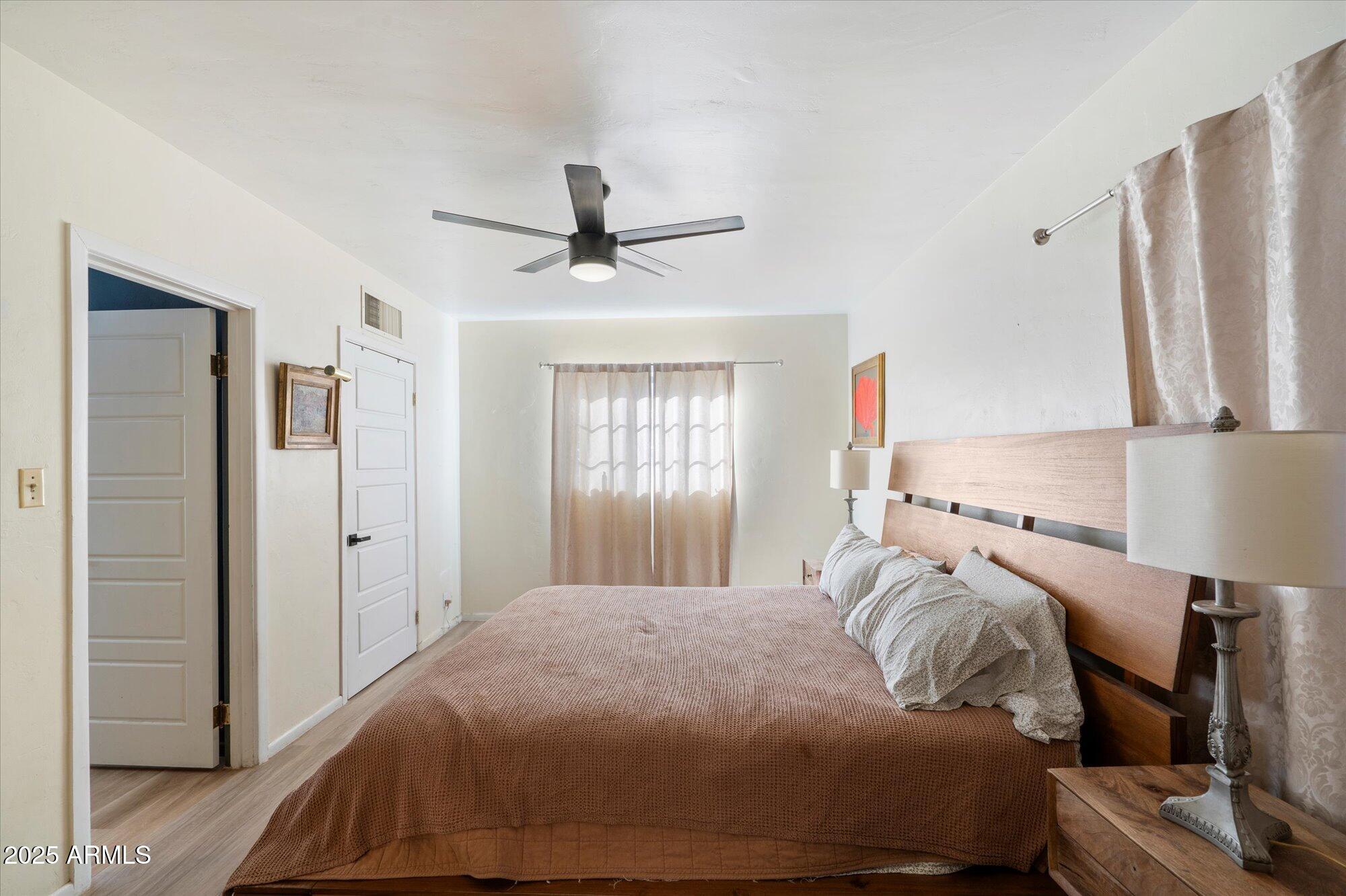 1405 East Osborn Road Phoenix, AZ 85014 - Photo 16 of 30 a bedroom with a bed and a large mirror