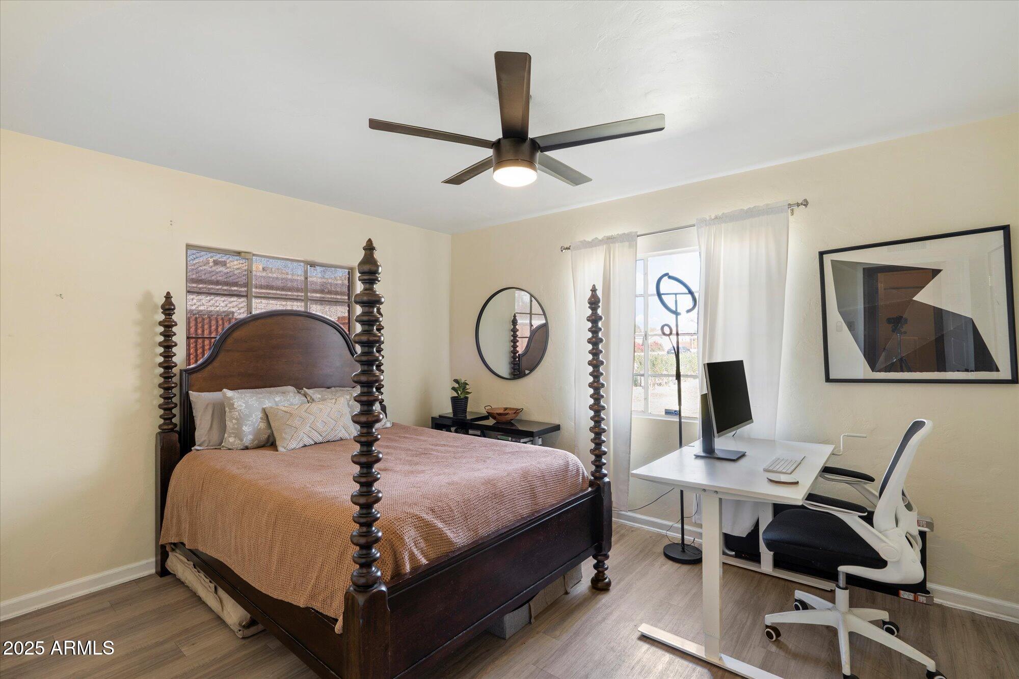 1405 East Osborn Road Phoenix, AZ 85014 - Photo 19 of 30 a bedroom with a bed a desk and chair