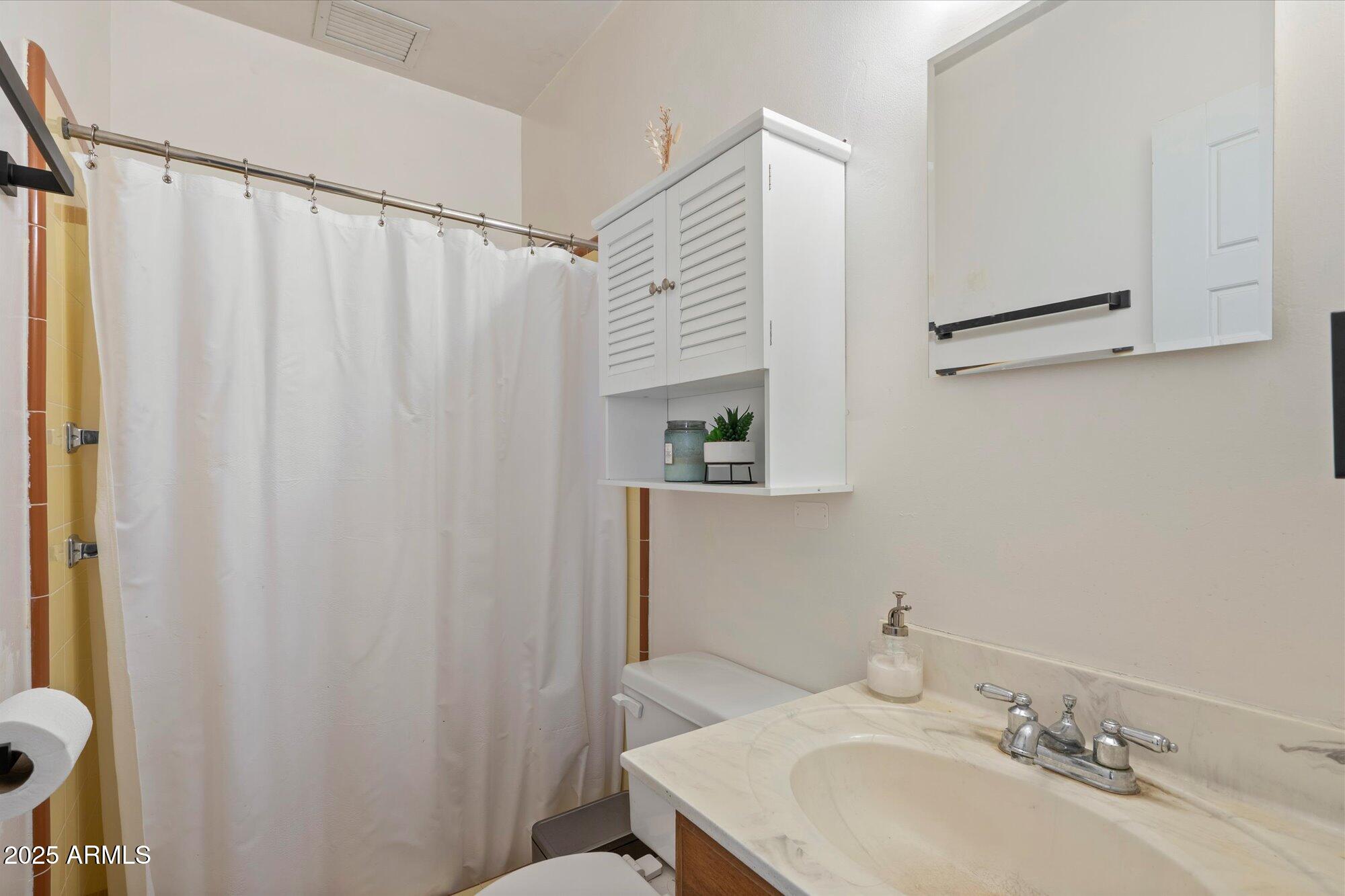 1405 East Osborn Road Phoenix, AZ 85014 - Photo 20 of 30 a bathroom with a sink and a mirror