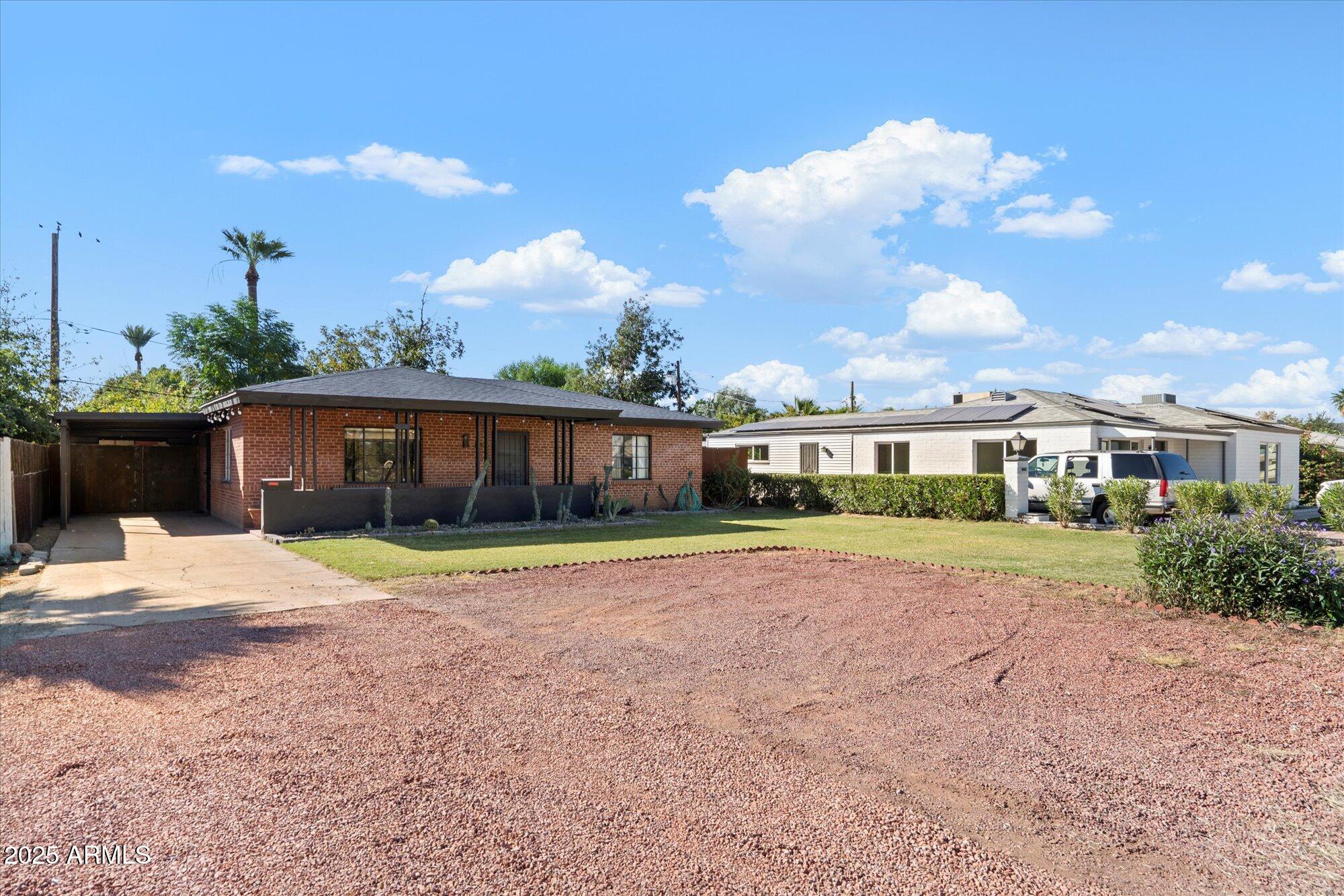 1405 East Osborn Road Phoenix, AZ 85014 - Photo 2 of 30 a front view of a house with a yard and potted plants