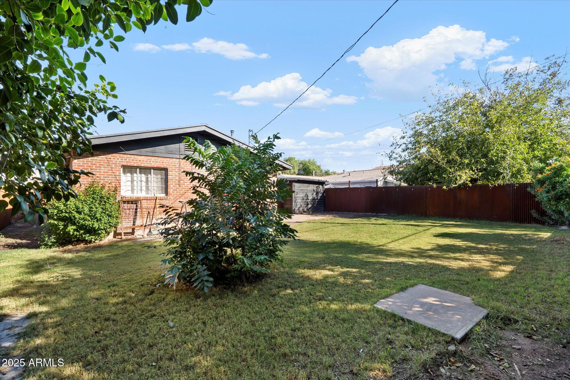 1405 East Osborn Road Phoenix, AZ 85014 - Photo 26 of 30 a view of a big yard with table and chairs potted plants and large tree