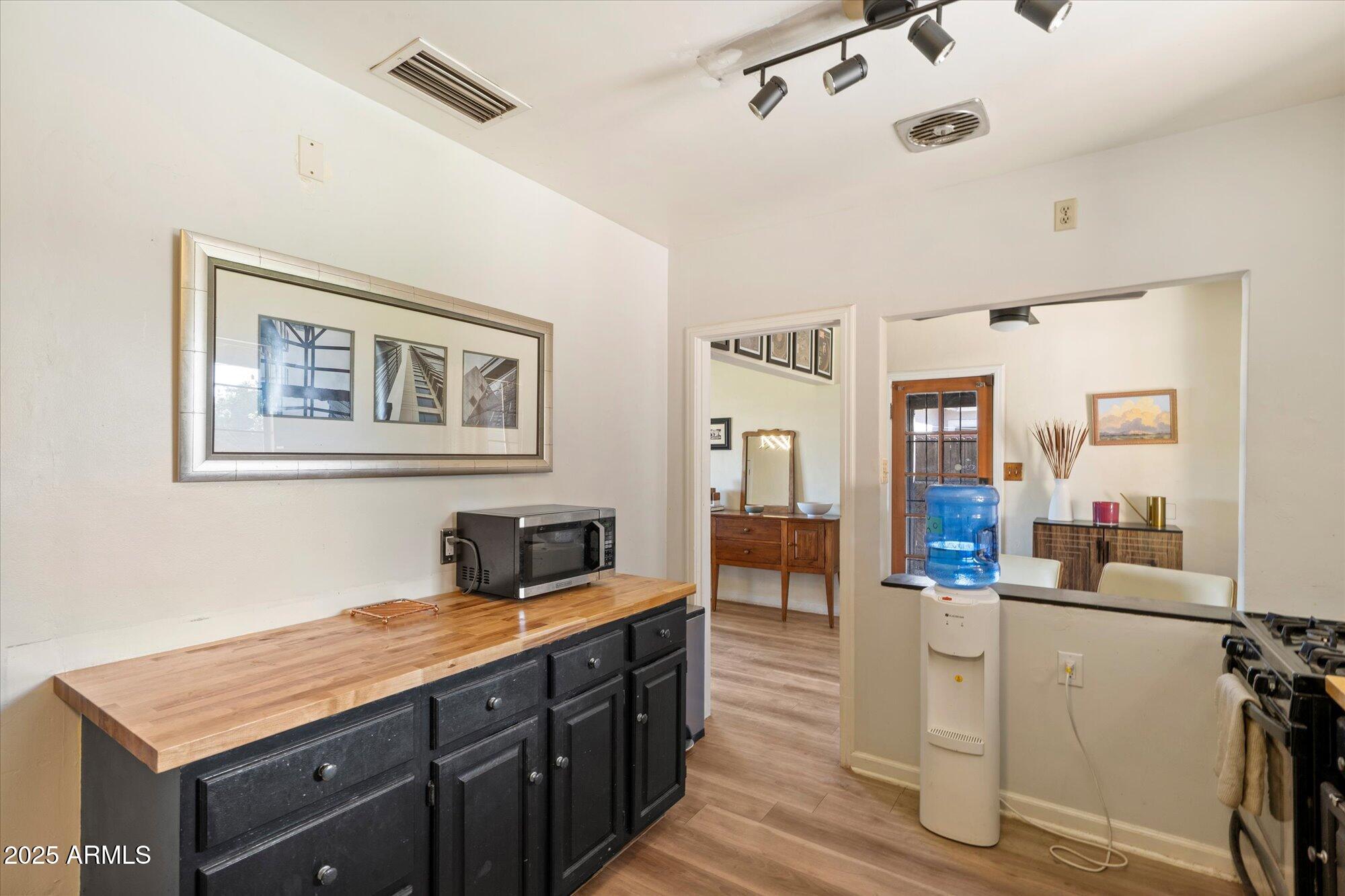 1405 East Osborn Road Phoenix, AZ 85014 - Photo 7 of 30 a hallway with a sink and cabinets