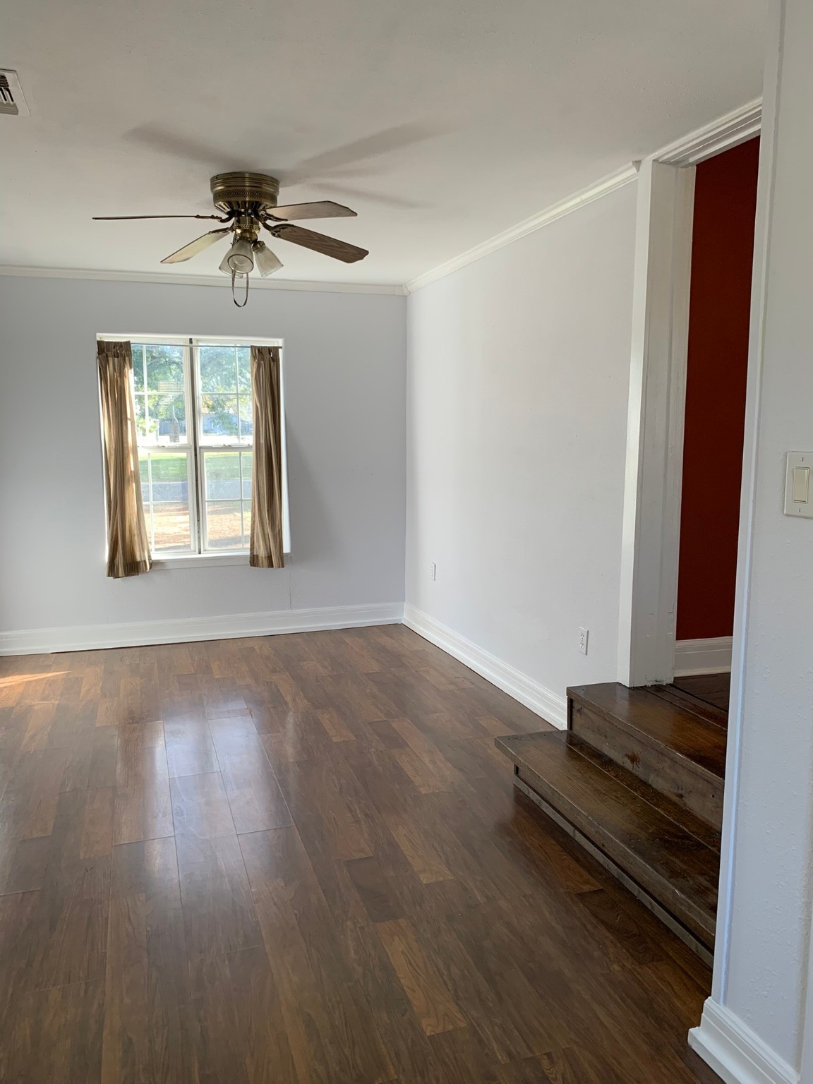 1315 Penick Road Waller, TX 77484 - Photo 11 of 13 an empty room with wooden floor fan and windows