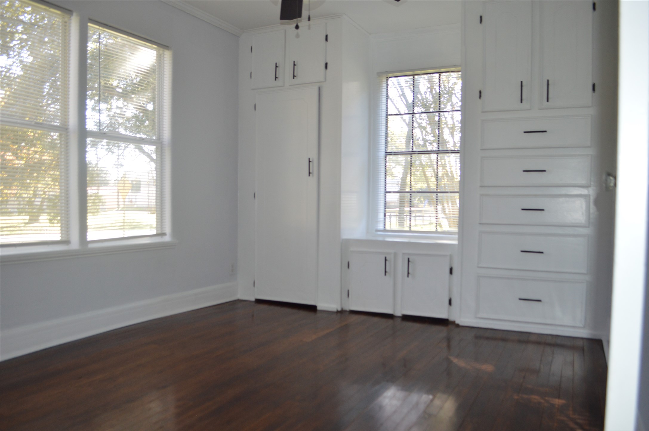 1315 Penick Road Waller, TX 77484 - Photo 12 of 13 an empty room with wooden floor and cabinet