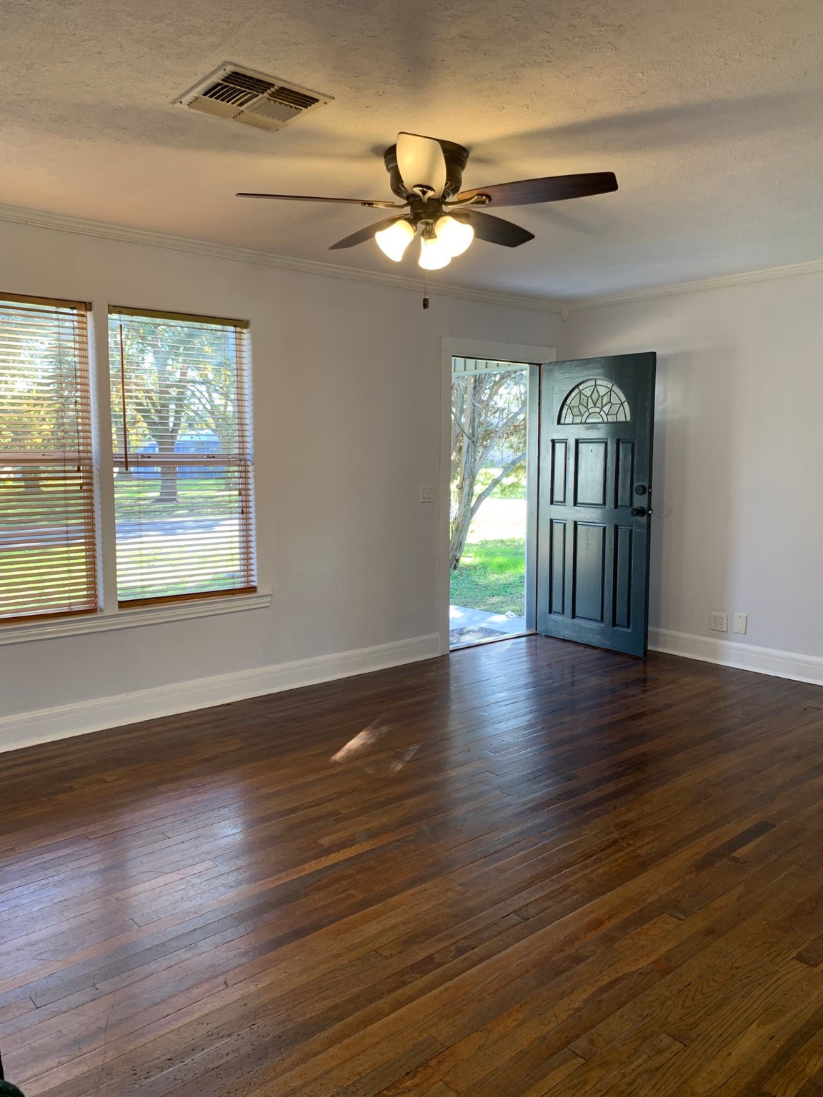 1315 Penick Road Waller, TX 77484 - Photo 2 of 13 a view of an empty room with wooden floor and a window