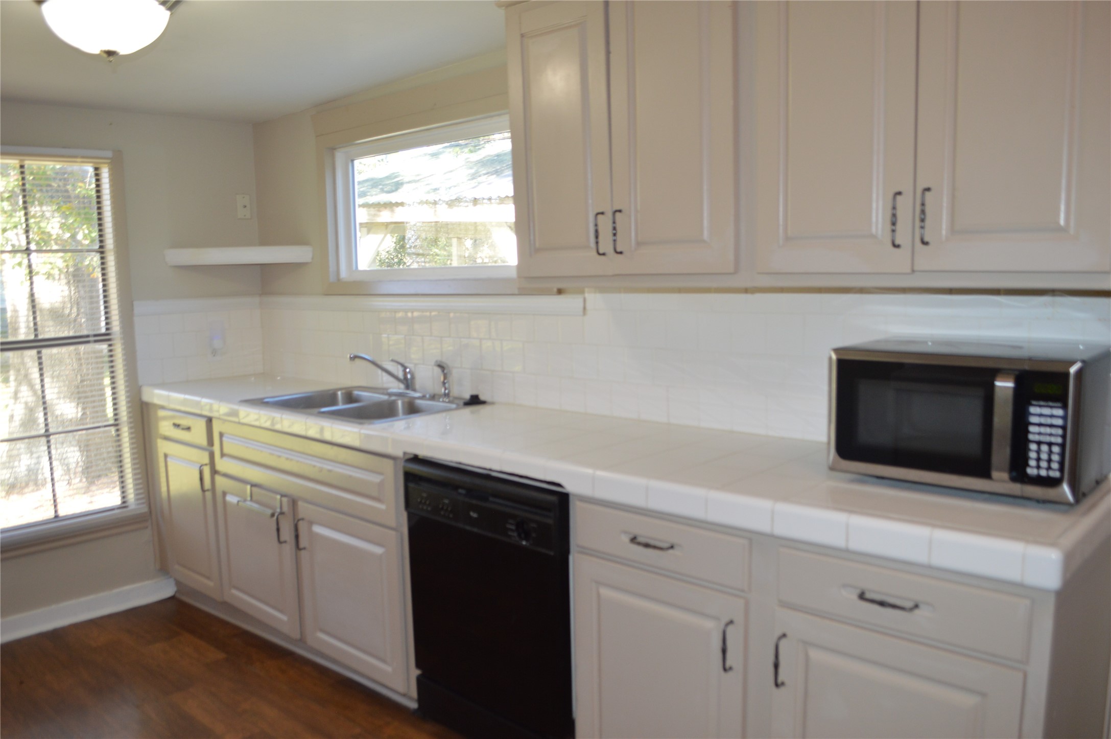 1315 Penick Road Waller, TX 77484 - Photo 5 of 13 a kitchen with granite countertop white cabinets white appliances and a sink