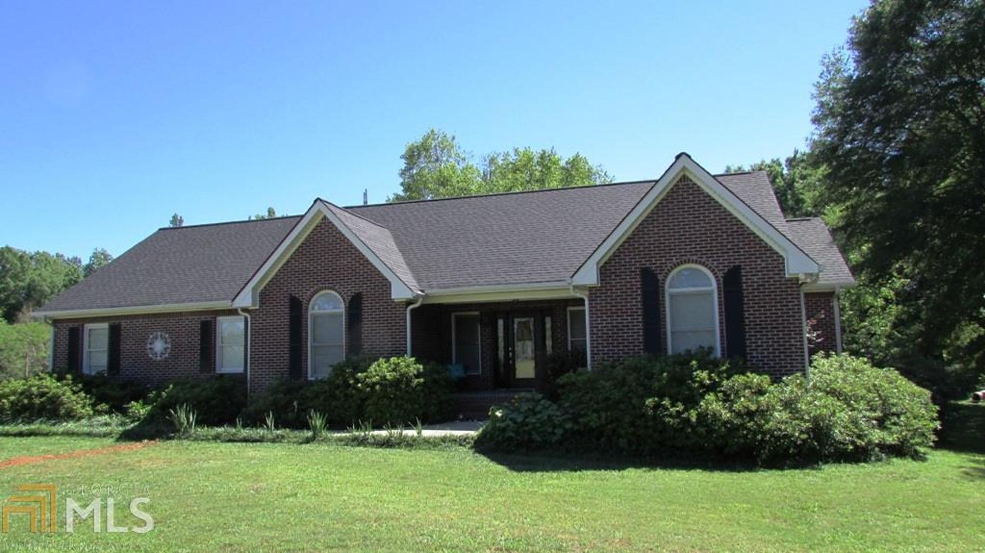 3927 Hester Town Road Madison, GA 30650 - Photo 1 of 1 a front view of a house with a yard