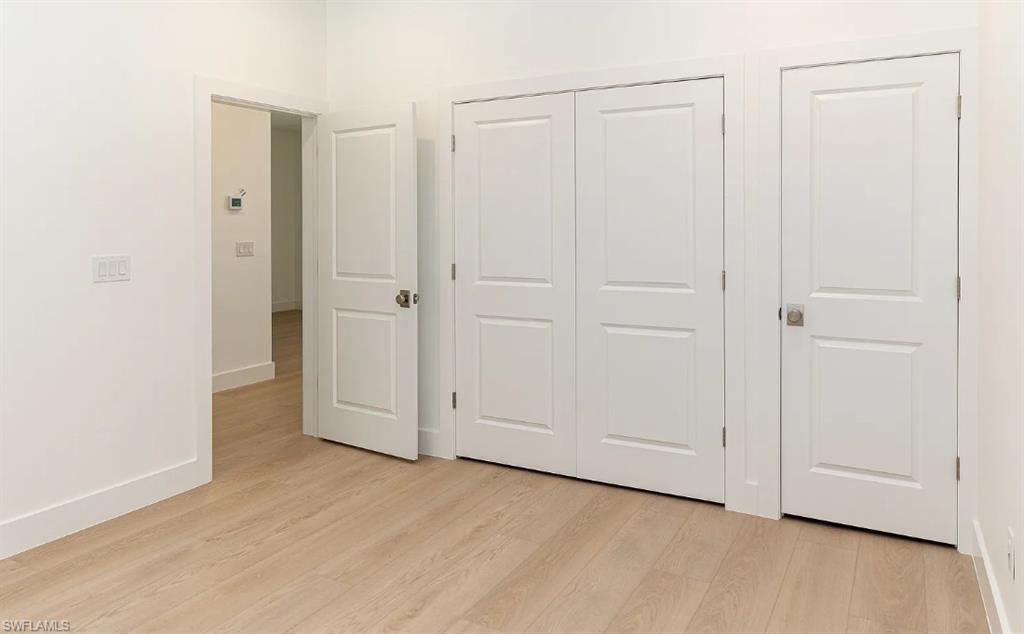 5588 Wendy Lane Naples, FL 34112 - Photo 20 of 37 an empty room with wooden floor