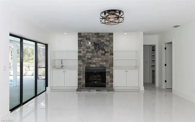 a view of an empty room with a kitchen