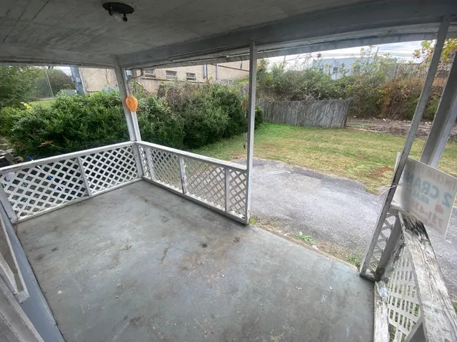 a kitchen with refrigerator and white cabinets