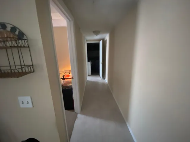 a bedroom with a bed and the view of bathroom