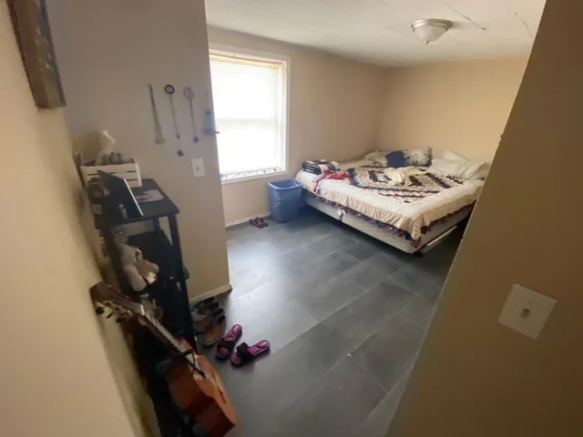 a kitchen with granite countertop lots of clutter and stainless steel appliances