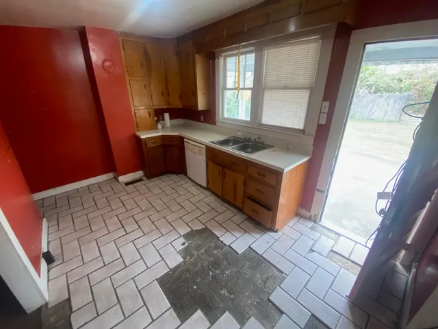 a kitchen with a sink a stove a refrigerator and window