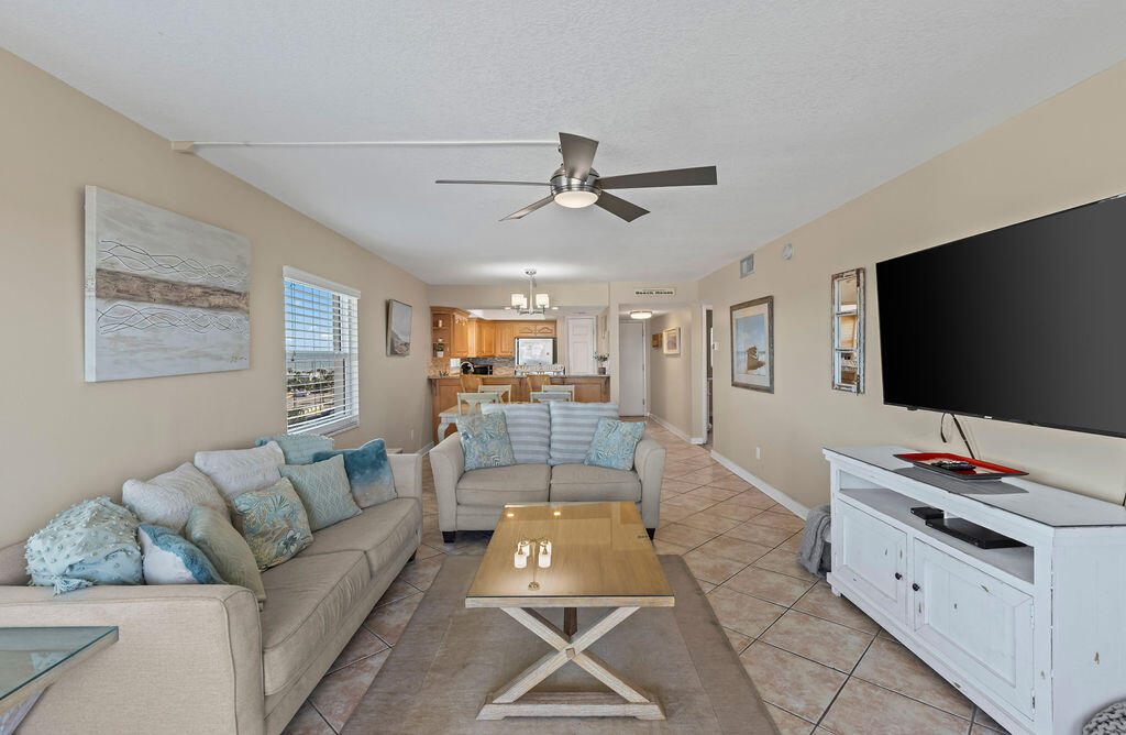 909 Santa Rosa Boulevard, Unit 569 Fort Walton Beach, FL 32548 - Photo 13 of 57 a living room with furniture and a flat screen tv