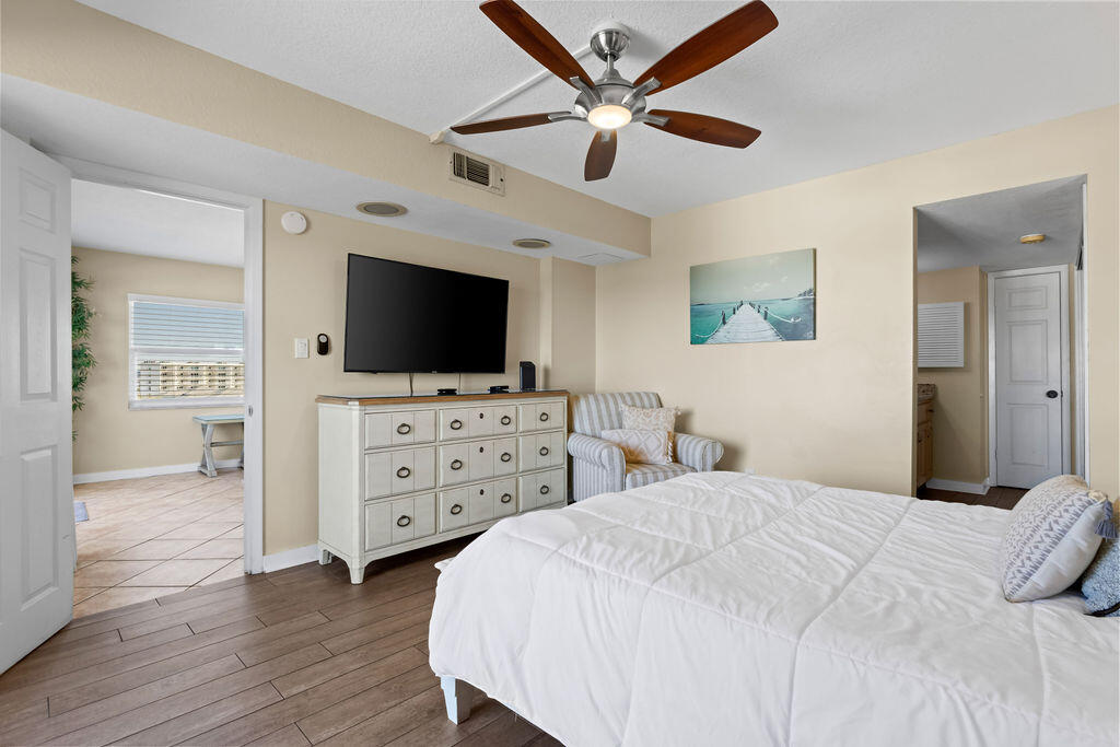 909 Santa Rosa Boulevard, Unit 569 Fort Walton Beach, FL 32548 - Photo 21 of 57 a bedroom with a bed and a flat screen tv