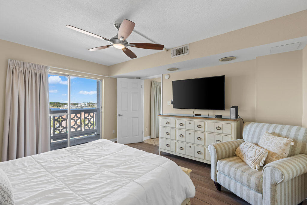 909 Santa Rosa Boulevard, Unit 569 Fort Walton Beach, FL 32548 - Photo 22 of 57 a bedroom with a bed and a flat screen tv